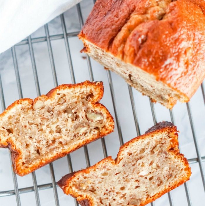 Two slices of banana bread from an easy recipe on a cooling rack.