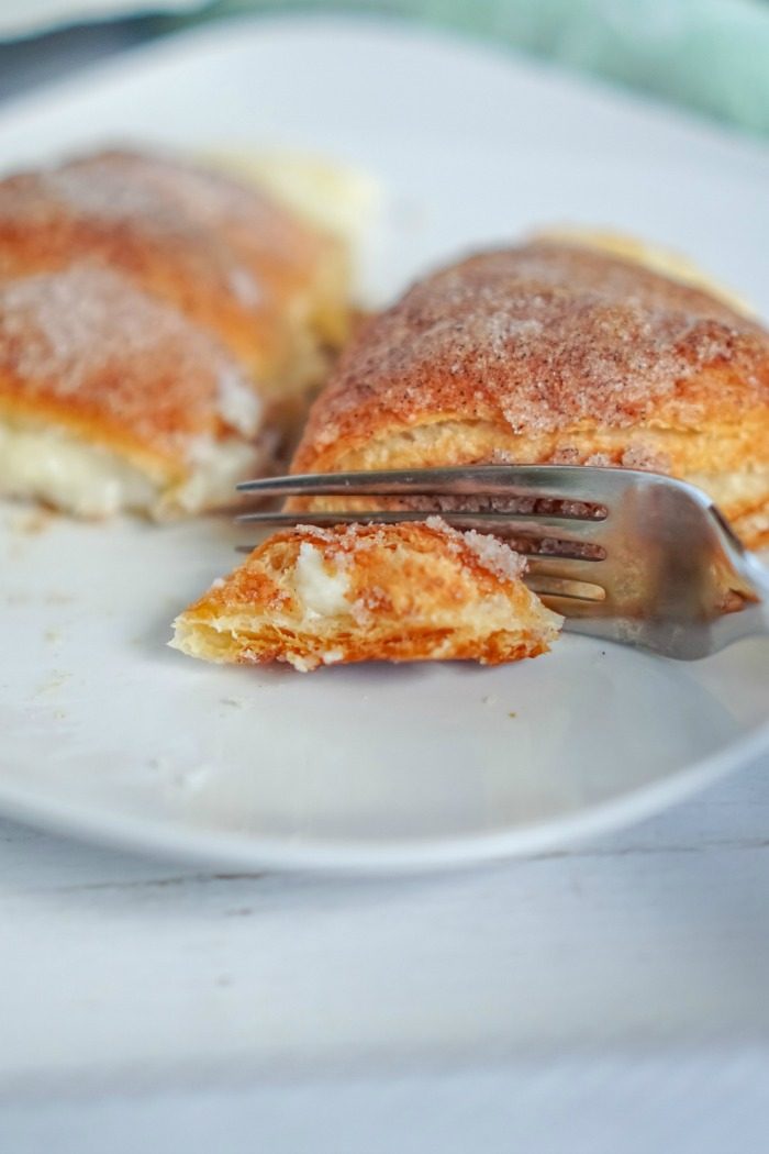 A plate with Easy Cheesecake Rollups and a fork.