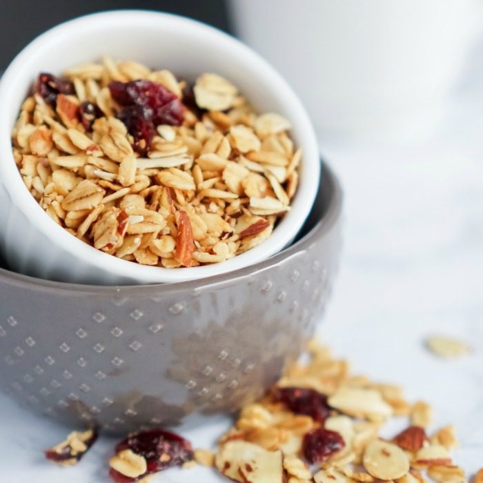 Baked granola in a bowl with cranberries.