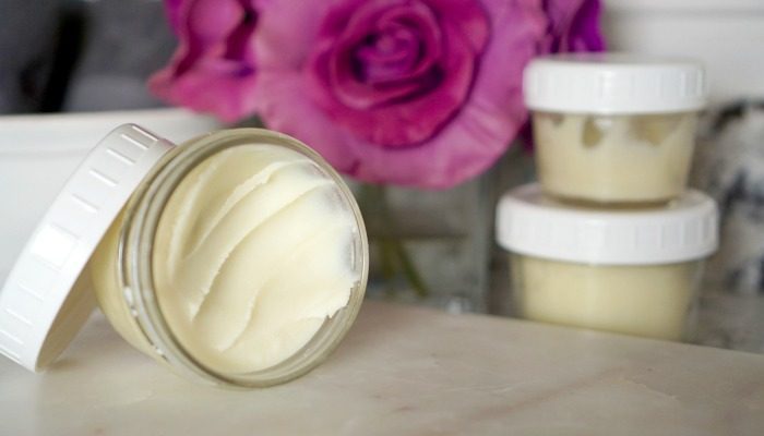 Three jars of DIY homemade body butter sitting on a counter.