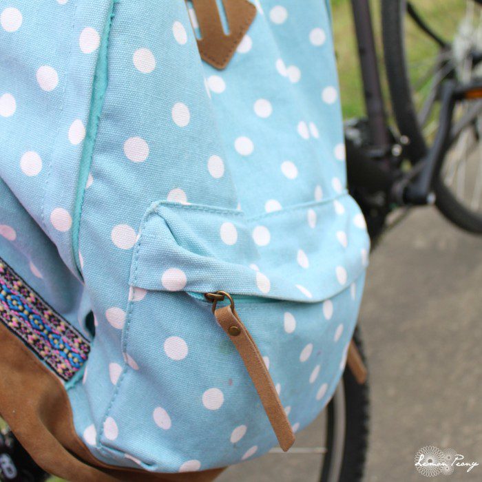 A blue and white polka dot backpack on a bike, offering simple gardening tips on how to plant potatoes.