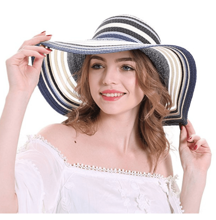 A woman wearing a cute striped summer hat.