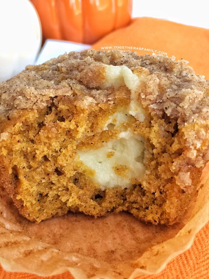 A pumpkin muffin from 15 Amazing Fall Pumpkin Recipes, with a bite taken out of it.