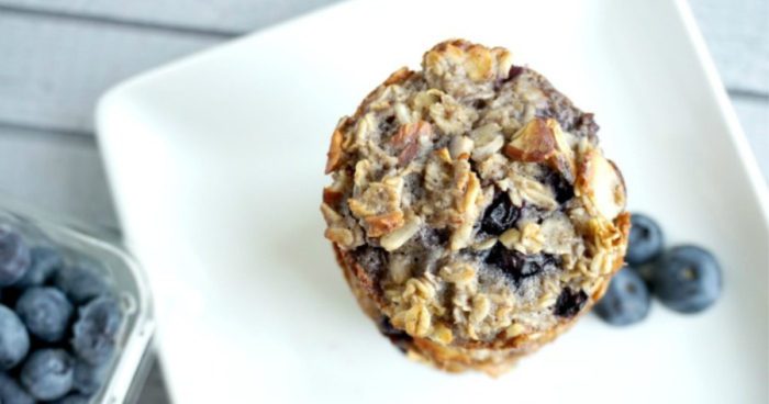 A stack of three oatmeal and blueberry muffins.