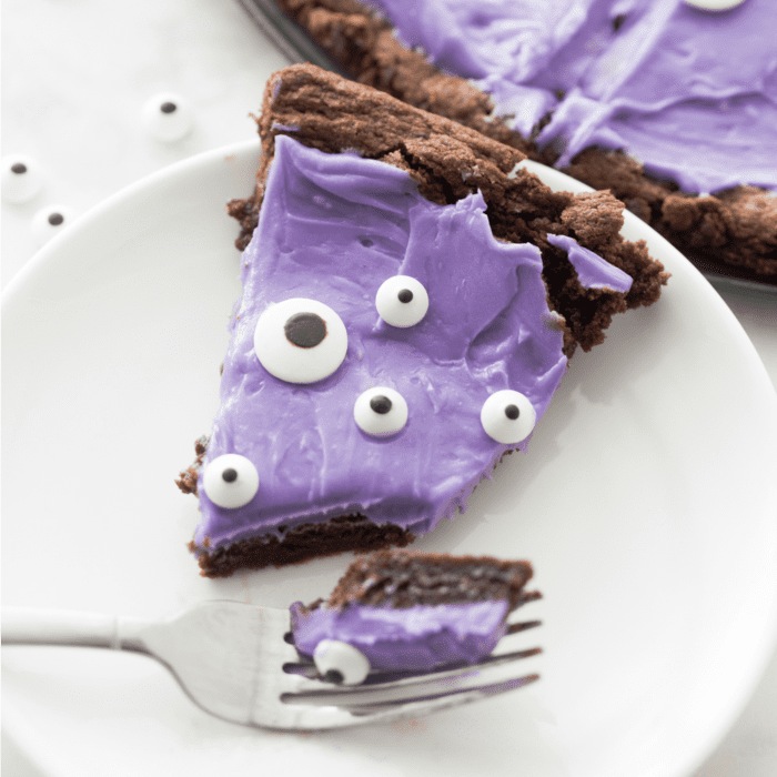 A purple pie with eyes on it on a plate, perfect as an easy Halloween treat for kids.