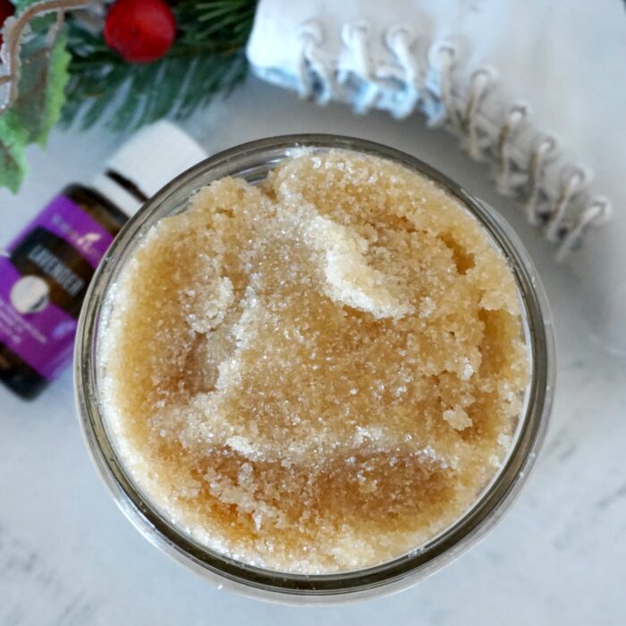 A jar of homemade sugar scrub next to a pair of boots.