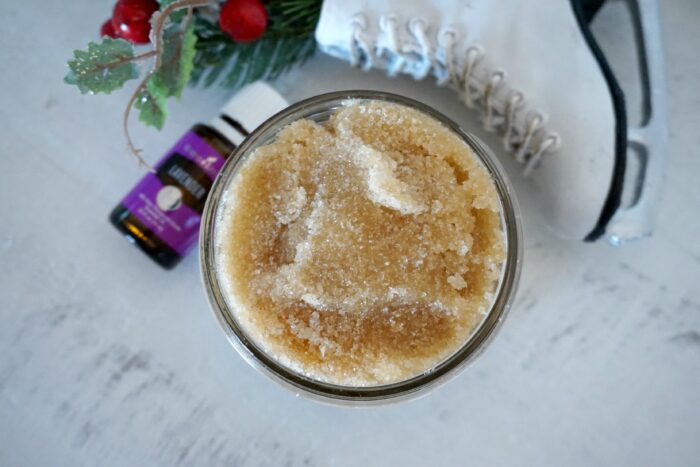 A jar of homemade sugar hand scrub next to a pair of ice skates.