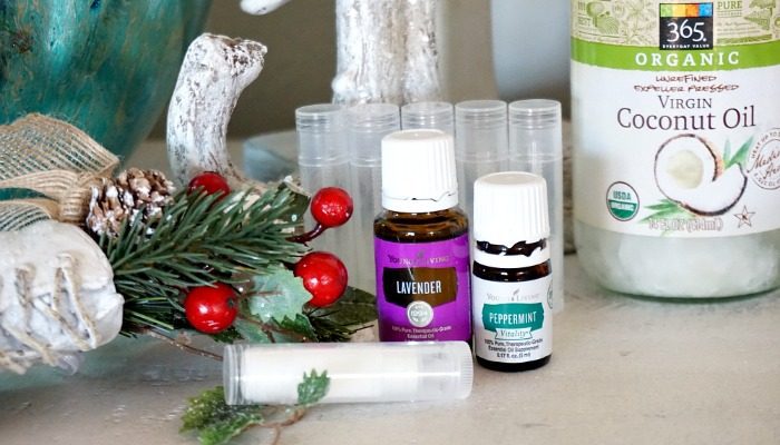 A bottle of coconut oil and a bottle of essential lavender oil on a table.