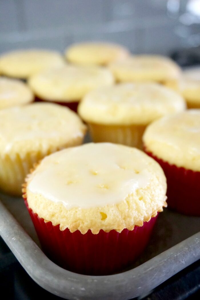 Easy lemon cupcakes with icing on a baking sheet.