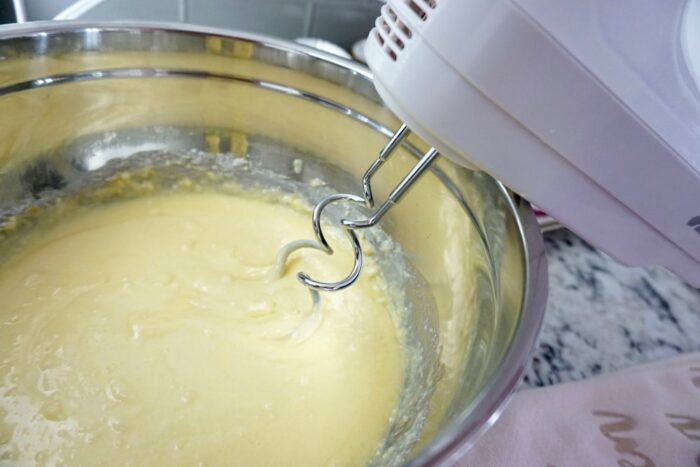 A mixer is being used to make an Easy Lemon Cupcakes batter.