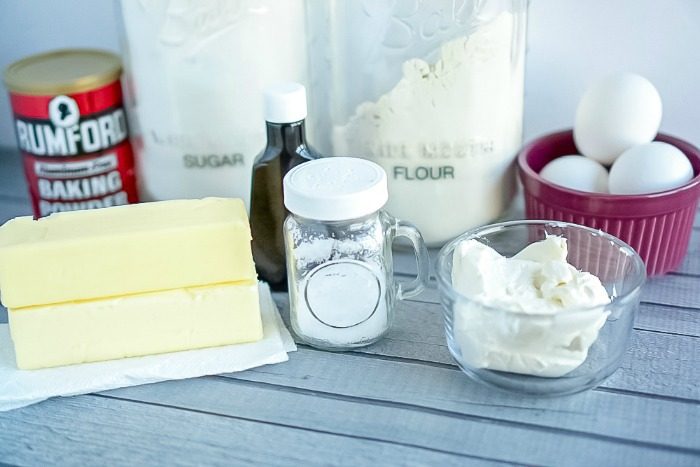 Butter, eggs, and other ingredients for homemade sugar cookie bars are on a table.