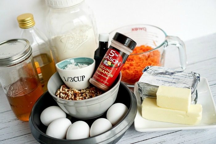 The ingredients for the Best Simple Carrot Cake Recipe are shown on a white plate.