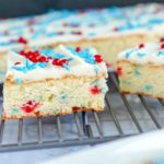 Cookie Bars for the 4th of July butter cream frosting red white and blue sprinkles on baking sheet