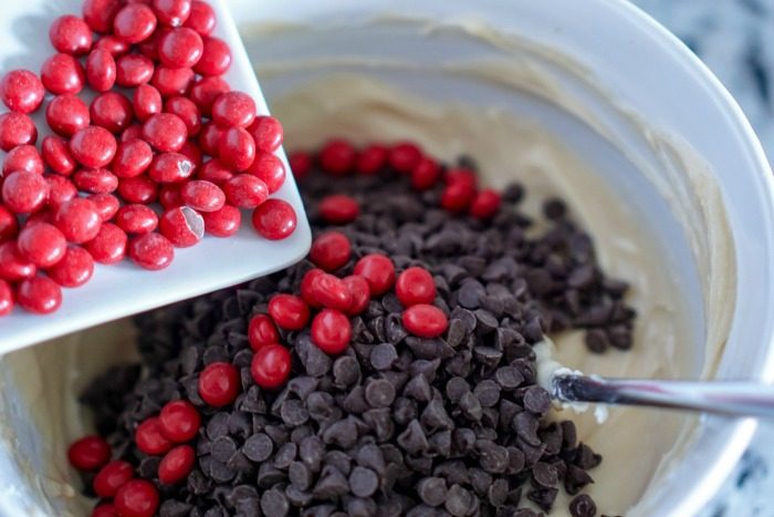 Chocolate Chip Cookie Dough Fruit Dip and red chips in a bowl for the 4th of July.