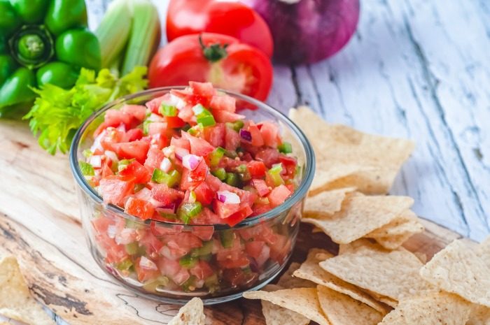 Easy Pico De Gallo Recipe on a wooden cutting board.