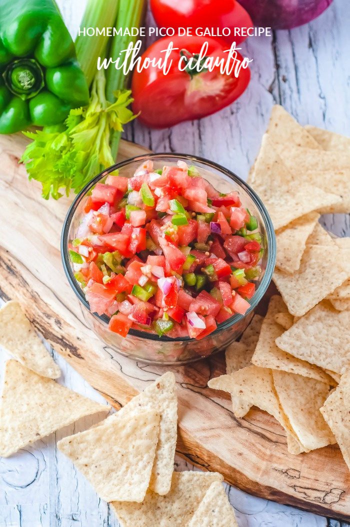 A bowl of easy Pico de Gallo salsa recipe without cilantro on a cutting board with tortilla chips.