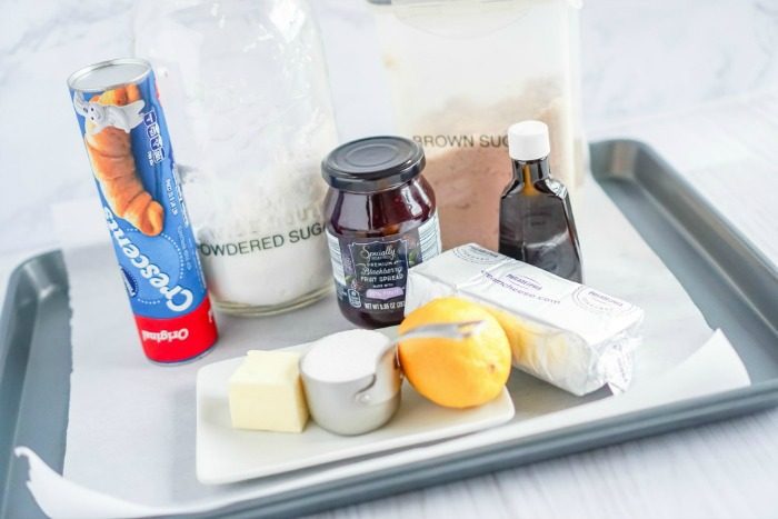 A baking tray with ingredients for an Easy Crescent Roll Cream Cheese Danish Recipe on it.