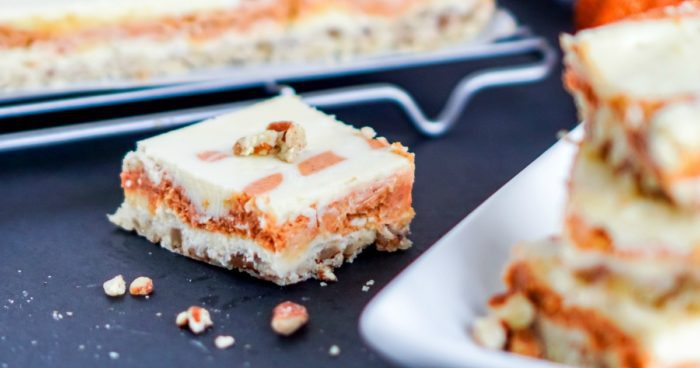 Amazing pumpkin cheesecake bars on a plate.