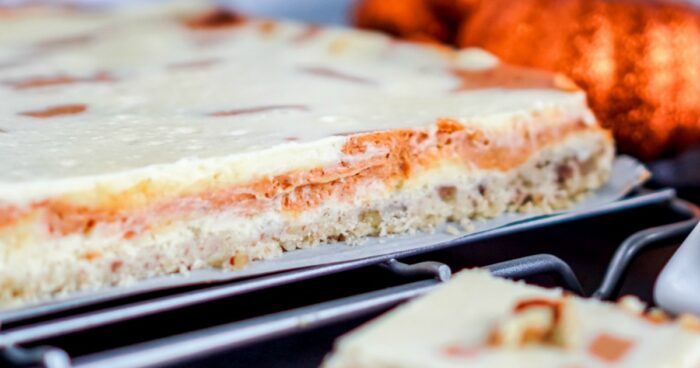 A slice of amazing pumpkin cheesecake on a cooling rack.