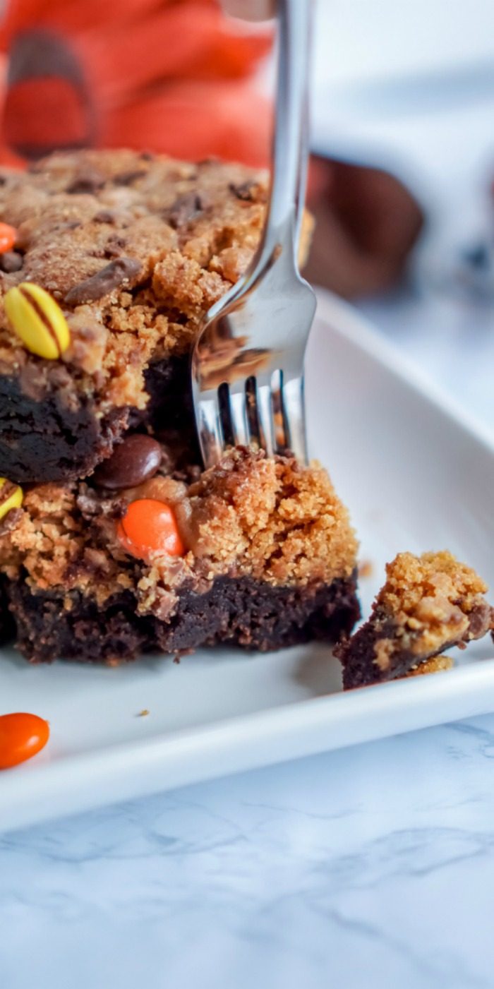 A person is holding a piece of Easy Pumpkin Peanut Butter Brownie with a fork.