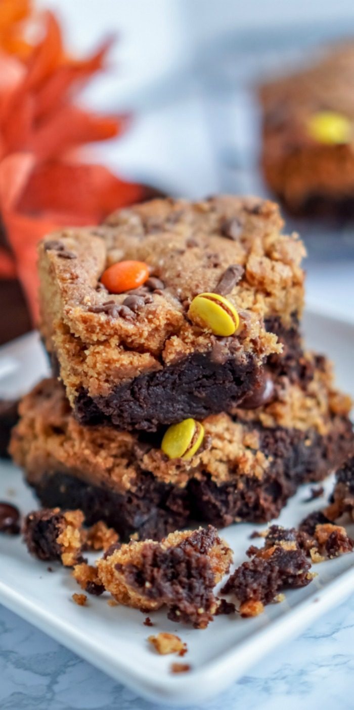 A stack of Pumpkin Peanut Butter Brownie bars on a white plate.