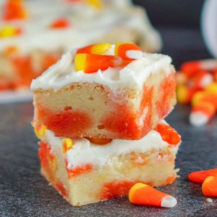 Amazing Thanksgiving dessert recipes feature candy corn bars stacked on top of each other.