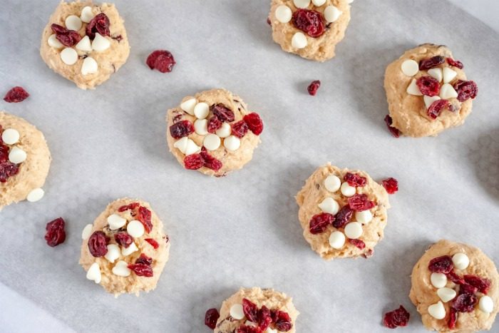 Cranberry White Chocolate Chip Cookies with Cinnamon on a baking sheet.