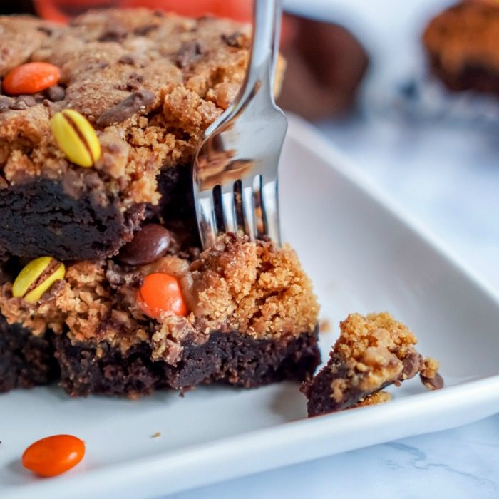 A stack of brownies on a plate with a fork, showcasing amazing Thanksgiving dessert recipes.