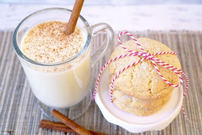 A glass of milk and amazing Christmas cinnamon cookies on a table.