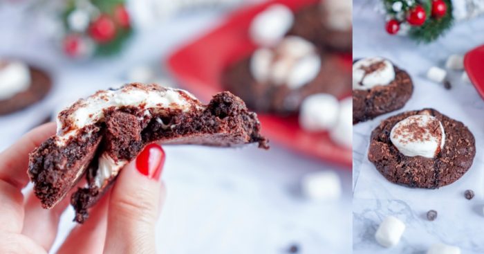 A person is holding a cocoa cookie with marshmallows on it.