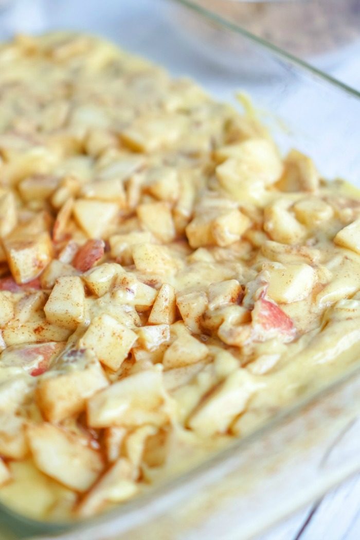 A glass baking dish with Apple Coffee Cake and Pecans in it.