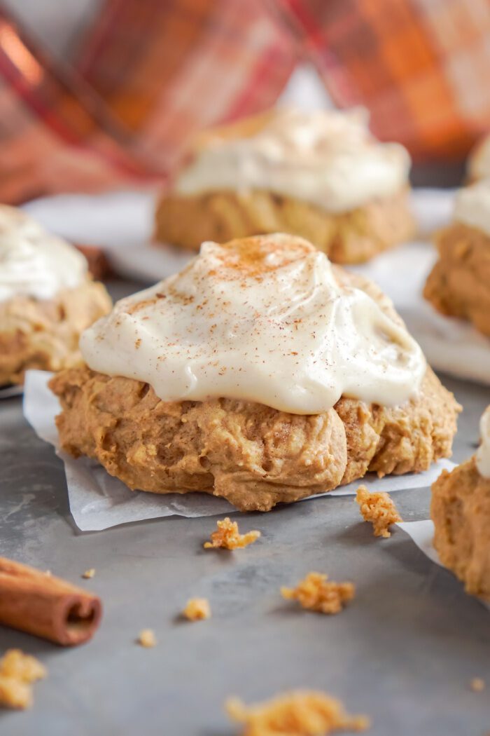 A close-up of pumpkin scones with cream cheese frosting.