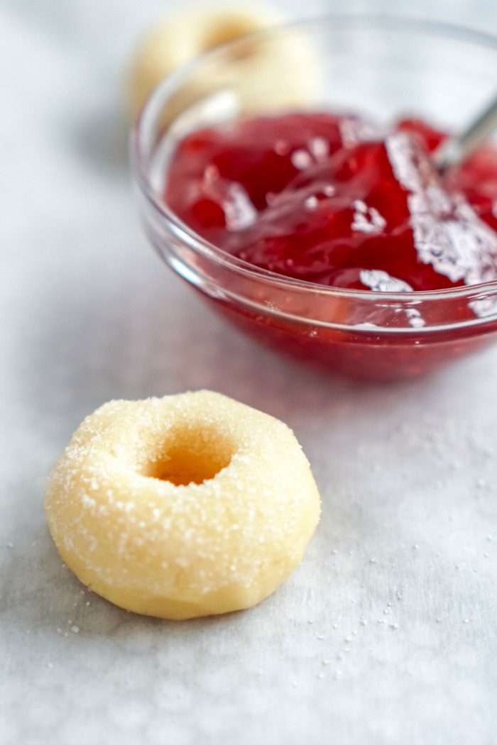 Donuts with Christmas jam in a bowl.