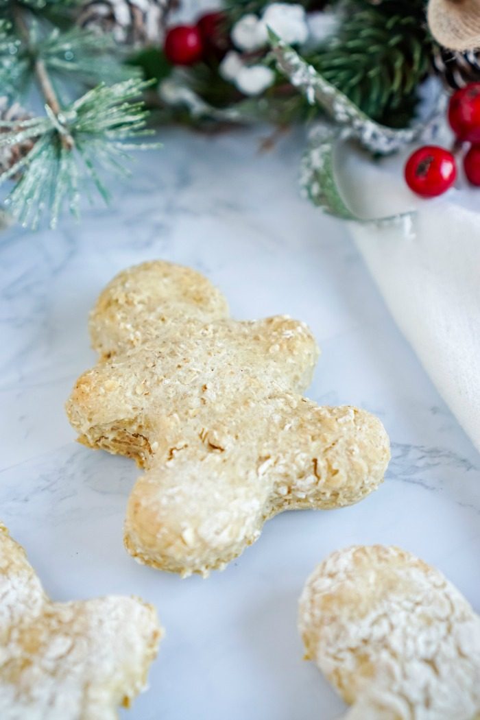 Homemade gingerbread cookies on a white marble table.