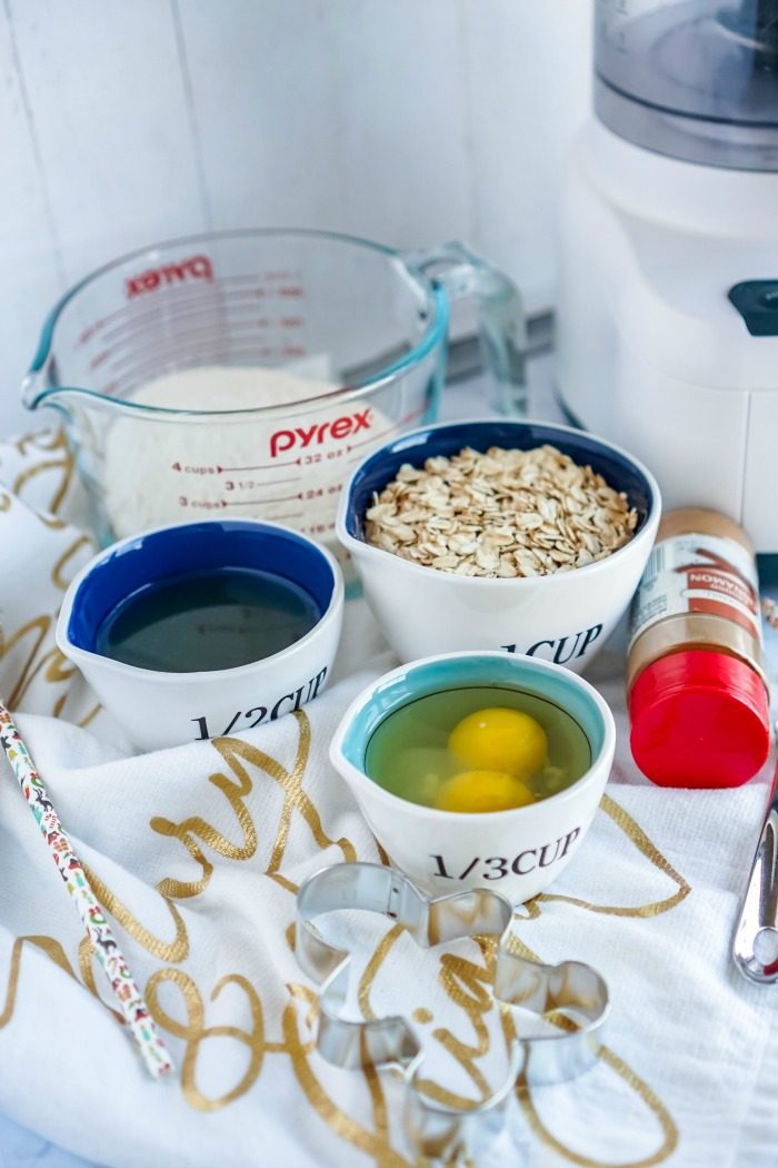 A food processor with ingredients for Homemade Christmas Cookie Dog Treats on a table.