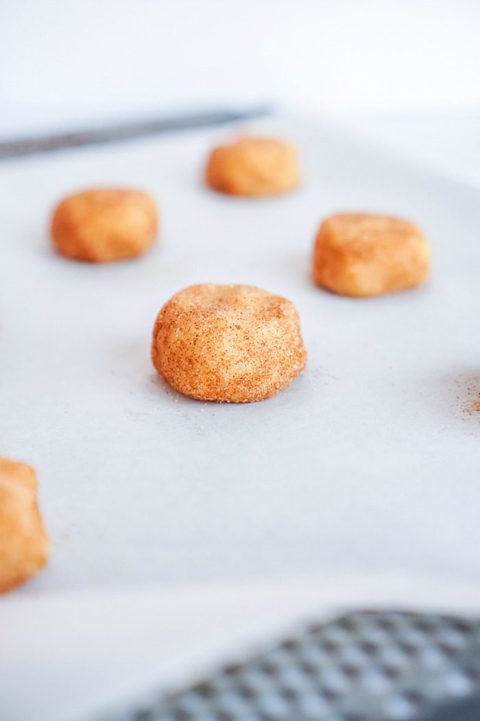 Easy Snickerdoodle donuts on a baking sheet.