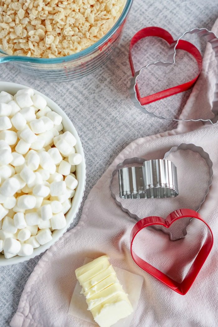 Valentine's Day Rice Krispie Treats and cookie cutters on a table.