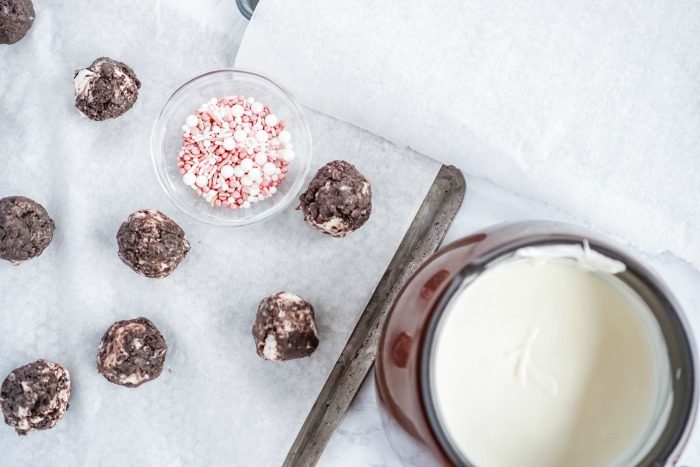 No Bake Oreo Cheesecake Balls with milk and sprinkles.