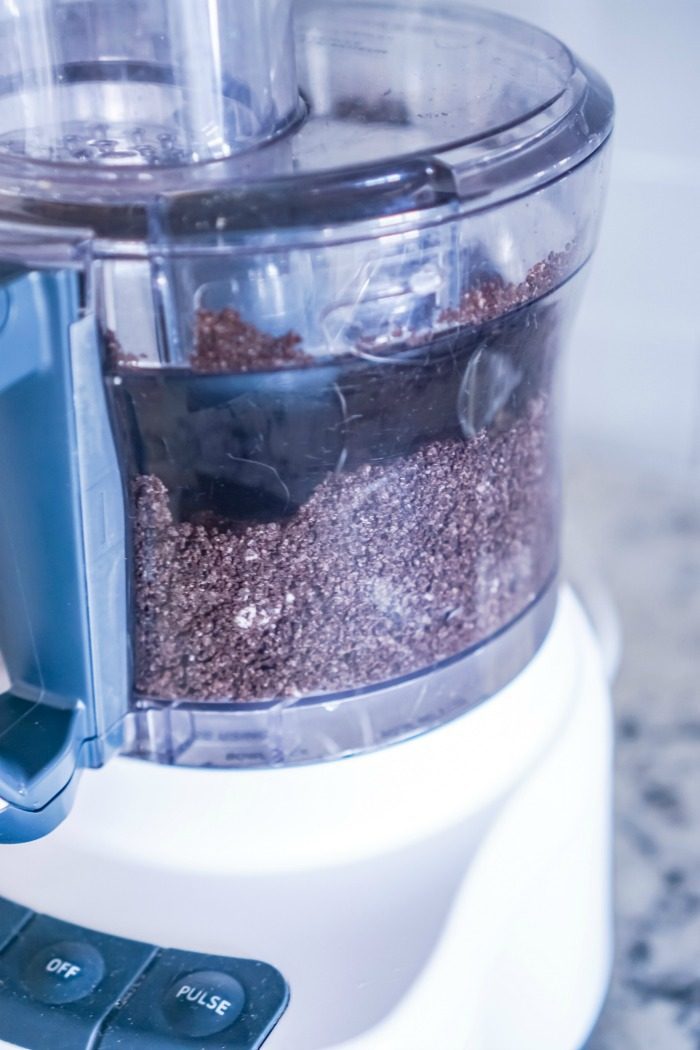 A food processor filled with ingredients for No Bake Oreo Cheesecake Balls.