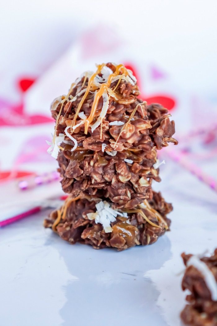 A stack of chocolate and peanut butter no bake cookies on a white table.