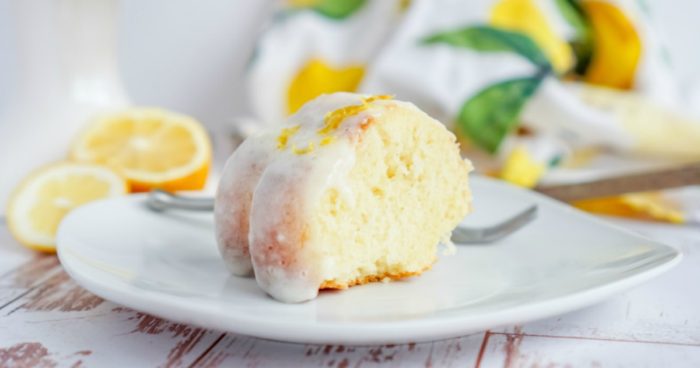 A slice of lemon bundt cake from a Lemon Cake Recipe on a white plate.