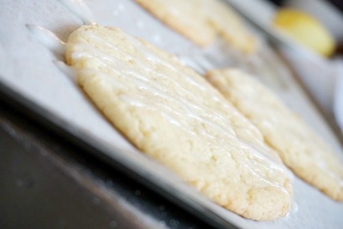 Amazing Lemon cookies with icing on a baking sheet.