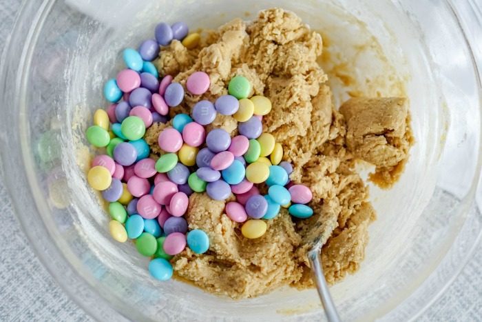 A bowl of cookie dough with colorful candies in it, perfect for an easy Easter Blondie Recipe.