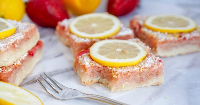 Strawberry Lemon Bars Recipe on a white plate with a fork.