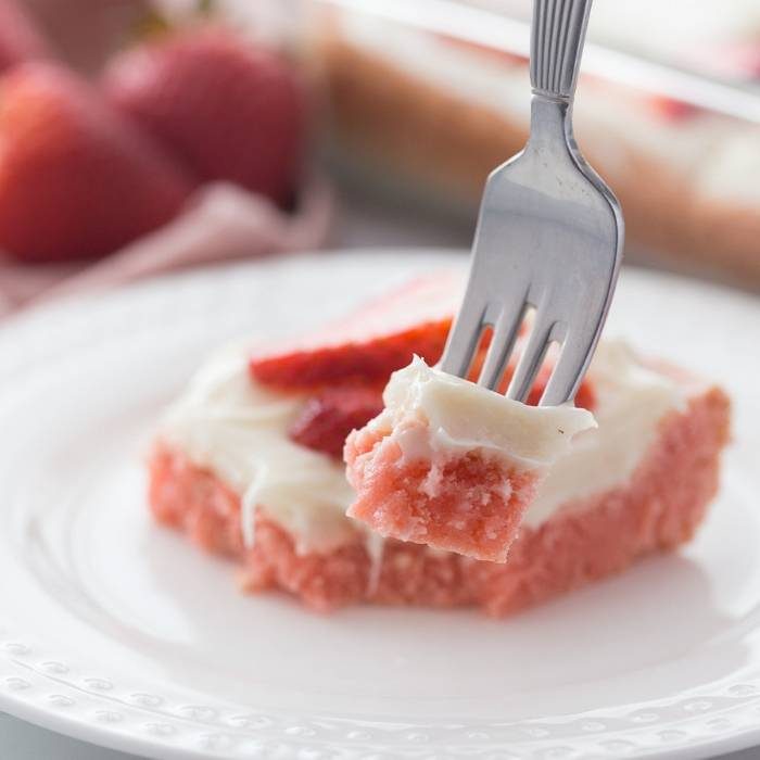 A forkful of strawberry poke cake.