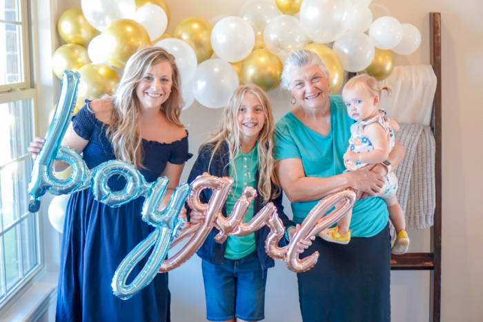 Four generations of women at a gender reveal party.