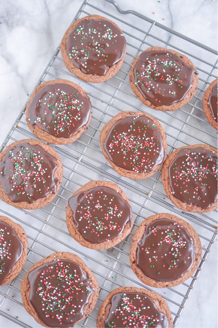 Round chocolate cookies with red and green sprinkles.