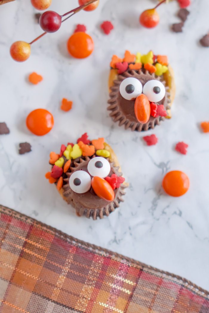 Two chocolate-covered pretzels decorated as turkeys.