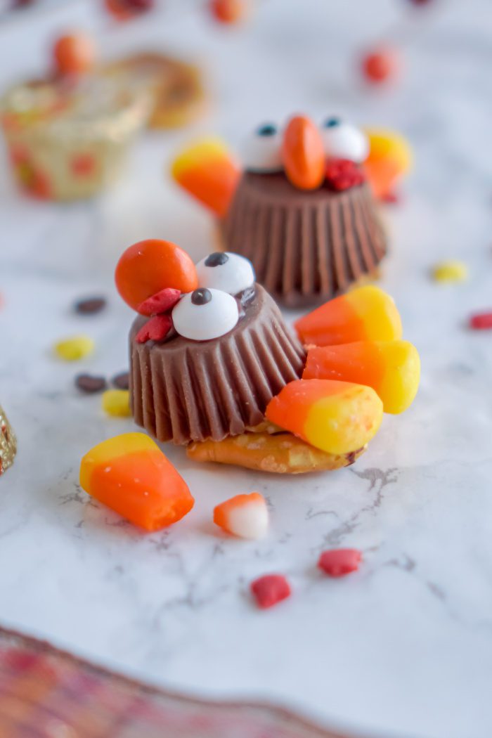 Thanksgiving turkey-shaped candies on marble table.