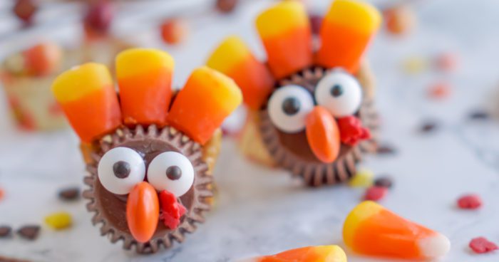 Two chocolate turkeys made of candy corn and chocolate kisses.